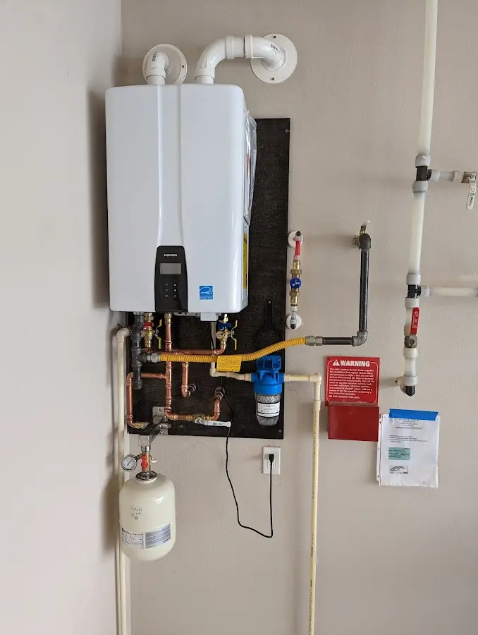 Professional plumber installing copper piping in a Hartford home